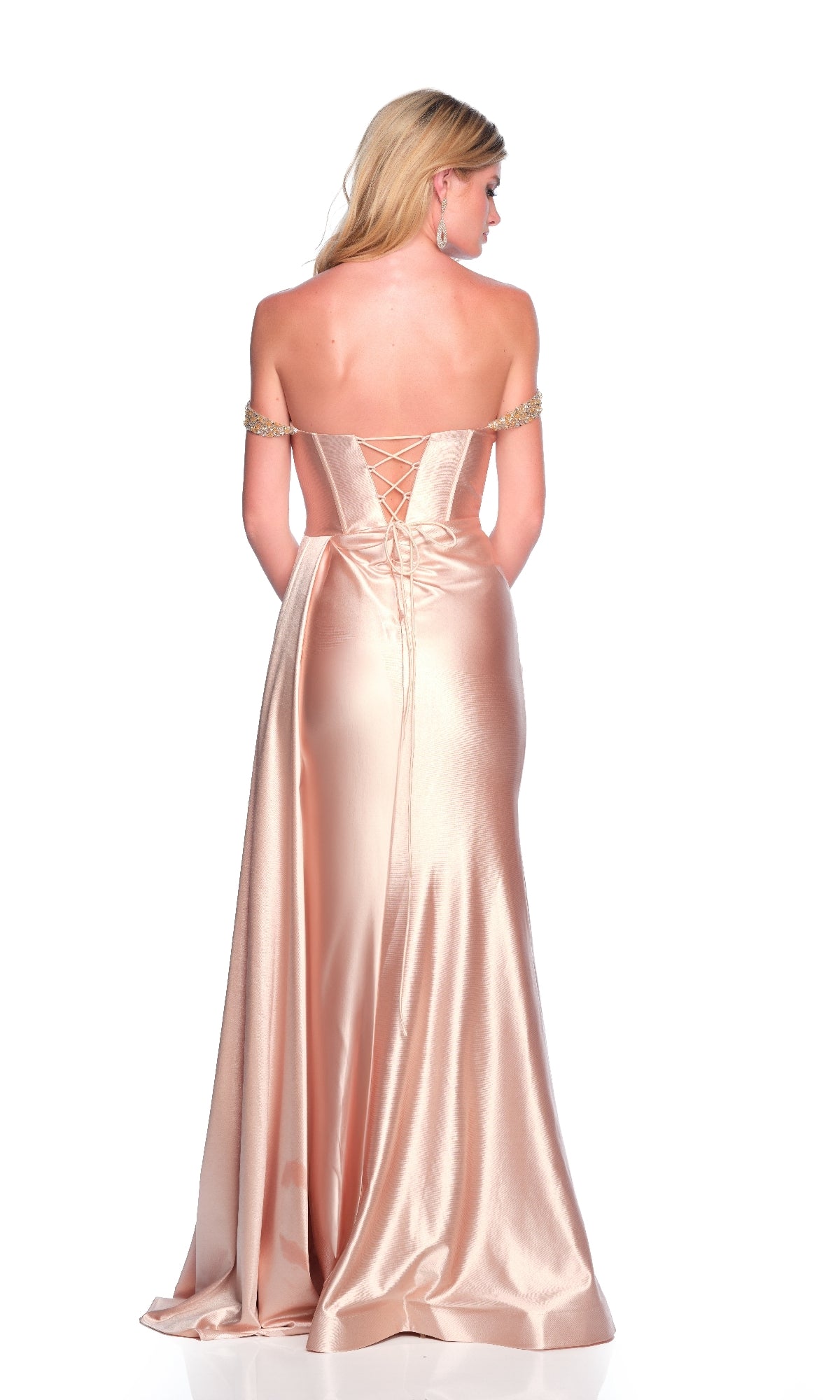 A woman wearing the Dave & Johnny 12291 long prom dress—a strapless, light pink satin gown with a corset bodice and lace-up back, featuring draped fabric—shown from behind.